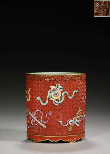 A red glaze famille rose eight treasures porcelain brush pot