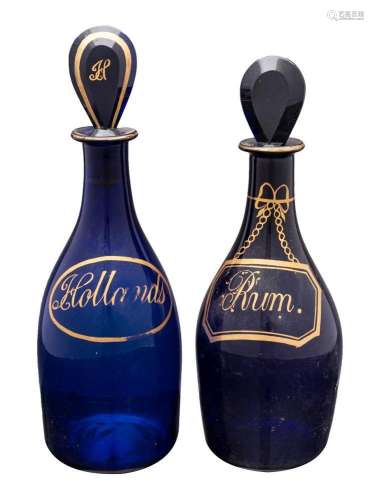 Two 'Bristol Blue' mallet shaped decanters, with loz...