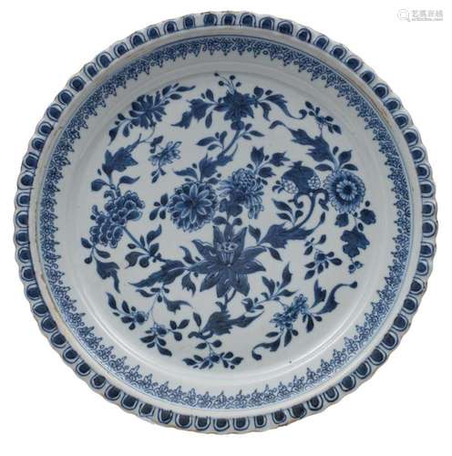 A Chinese blue and white dish with moulded foliate rim, pain...