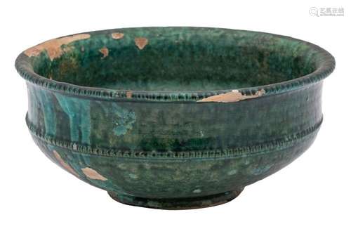 A Chinese green glazed pottery bowl with indented rim and be...