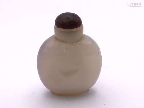 A polished agate bottle with a natural darkened ar