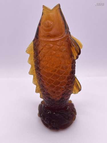 A carved amber glass snuff bottle in the form of a