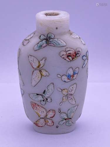 A hand painted milk glass and enamel decorated bot