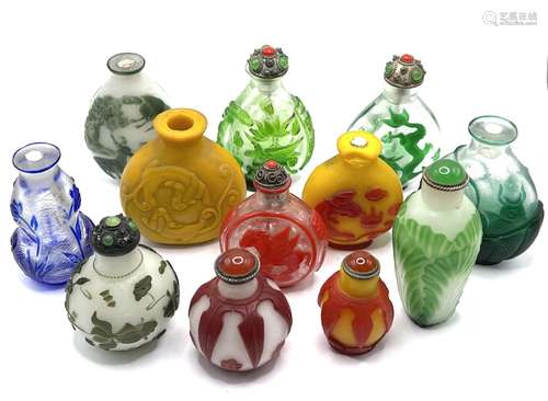 A collection of varied cameo glass snuff bottles.