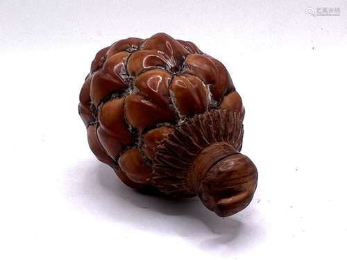 A Chinese pinecone repurposed for use a a snuff bo