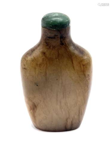 A carved jade snuff bottle with green jade stopper