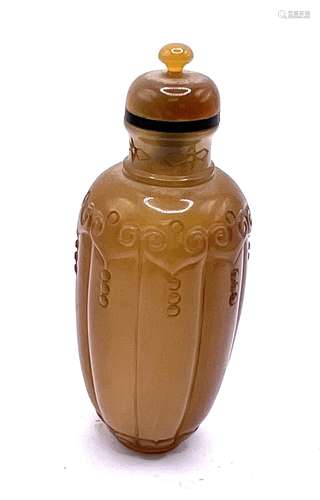 A finely carved polished agate snuff bottle with m