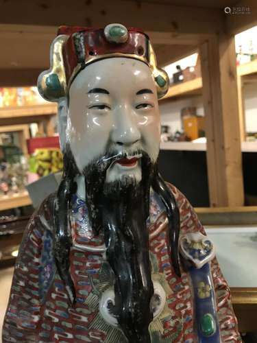 A Chinese porcelain imperial figure decorated in t