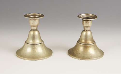 A pair of Dutch silver candlesticks, each sconce upon a step...
