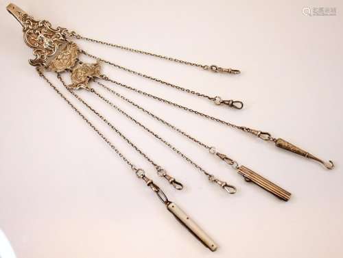 A silver coloured Victorian chatelaine, the clip  depicting ...