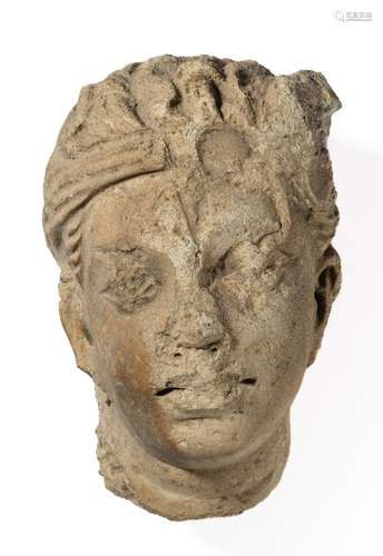 A GANDHARA STUCCO HEAD OF A DEVOTEE, NORTH-WESTERN PAKISTAN,...