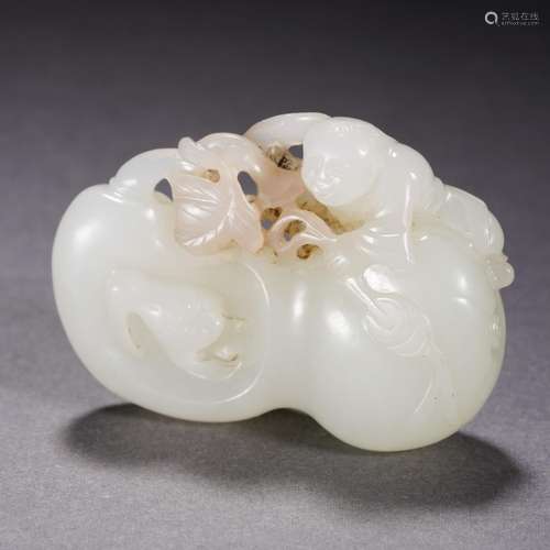 A Carved White Jade Kid with Mellons