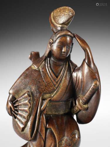 A MASTERFUL AND VERY RARE LACQUERED WOOD NETSUKE OF IZUMO NO...