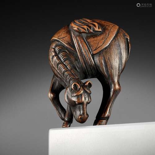 A FINE WOOD NETSUKE OF A GRAZING HORSE