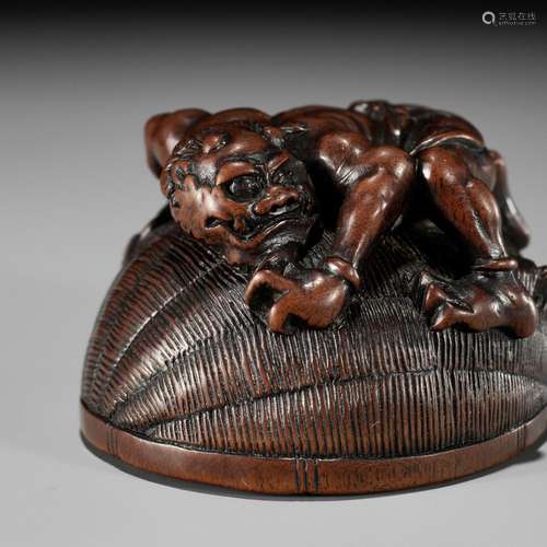 MASANAO: A RARE WOOD NETSUKE OF AN ONI TRAPPING SHOKI