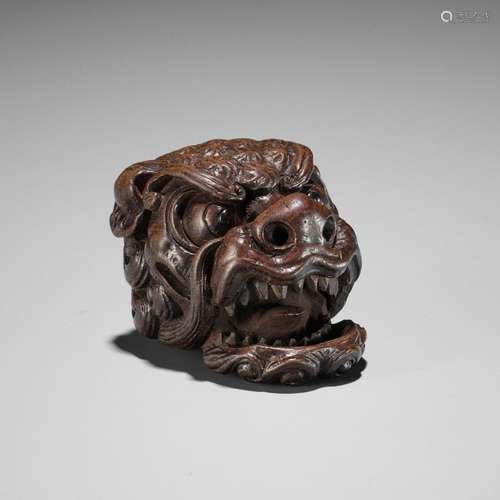 TAMETAKA: A SUPERB WOOD MASK NETSUKE OF A SHISHI