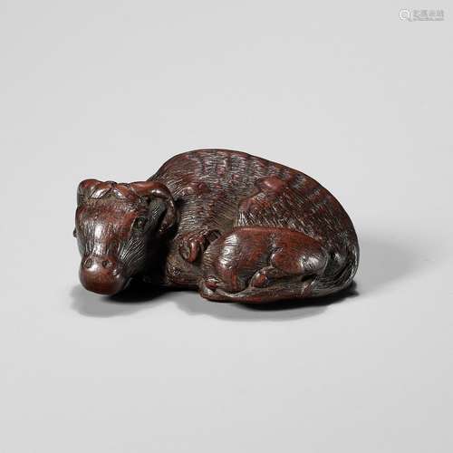 【†】 A SUPERB AND VERY RARE WOOD NETSUKE OF AN OX AND CALF, A...