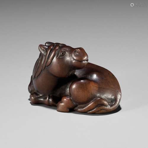 A FINE WOOD NETSUKE OF A RECUMBENT HORSE