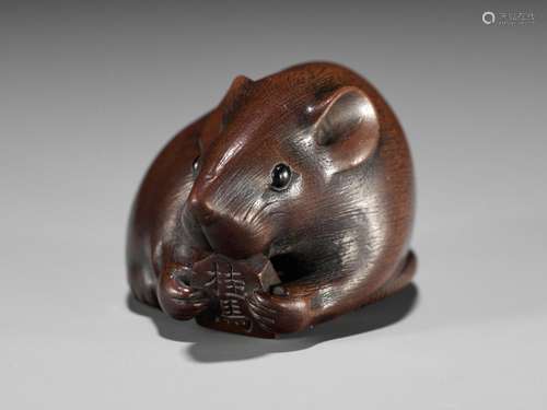 KANO TOMOKAZU: A FINE WOOD NETSUKE OF A RAT BITING INTO A SH...