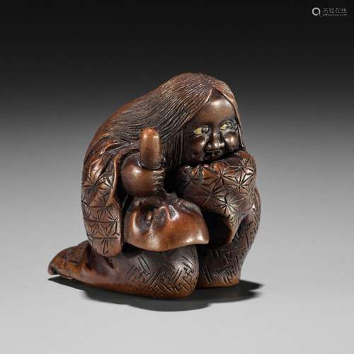 NOBUKAZU: A WOOD SHUNGA NETSUKE OF OKAME WITH TENGU MASK