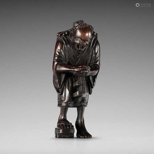 A FINE NAGOYA SCHOOL WOOD NETSUKE OF THE OIL THIEF