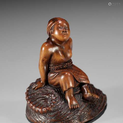 MASAKATSU: A RARE WOOD NETSUKE OF A CLAM DIVER RESTING ON A ...