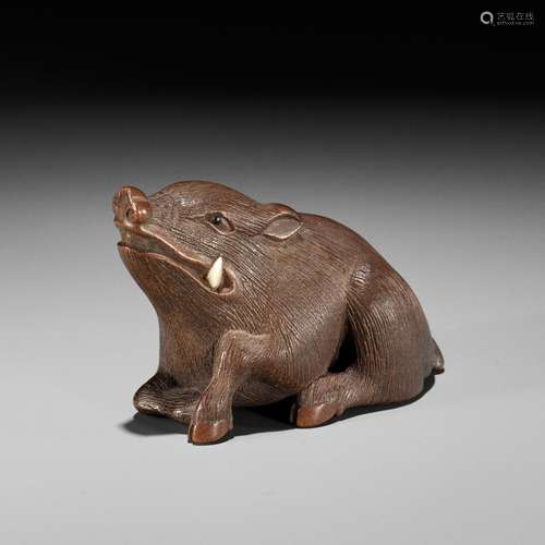 MASANAO: A FINE WOOD NETSUKE OF A RECUMBENT BOAR