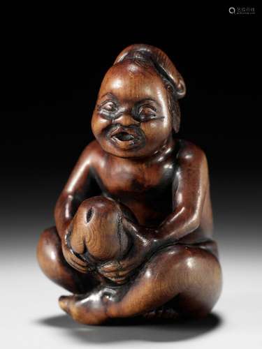 A SUPERB WOOD SHUNGA NETSUKE OF A MAN WITH OKAME MASK