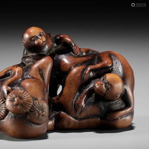 GENRYOSAI MINKOKU: A RARE WOOD NETSUKE OF TWO MONKEYS ON A P...