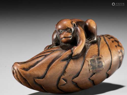 A FINE WOOD NETSUKE OF A MONKEY ON BAMBOO SHOOT