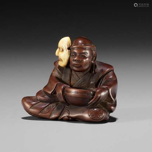 RYUKEI II: A FINE WOOD NETSUKE OF AN ACTOR WITH A BUAKU MASK