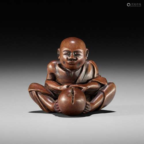 AN AMUSING EDO SCHOOL WOOD SHUNGA NETSUKE OF A MAN CUTTING A...