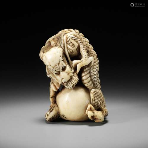 A POWERFUL STAG ANTLER NETSUKE OF A DRAGON WITH TAMA, ATTRIB...