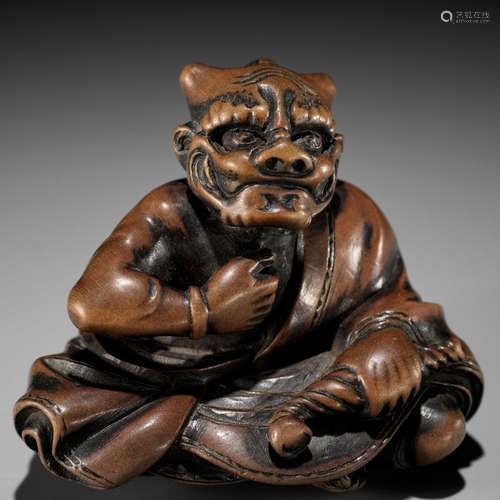 MASAYUKI: A FINE WOOD NETSUKE OF A SMOKING ONI