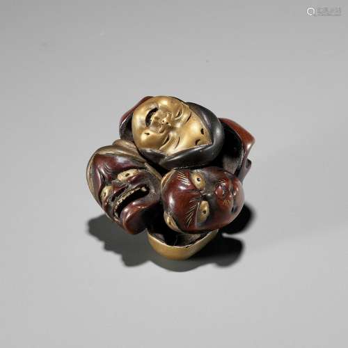 【†】 A LACQUER NETSUKE OF A CLUSTER OF MASKS