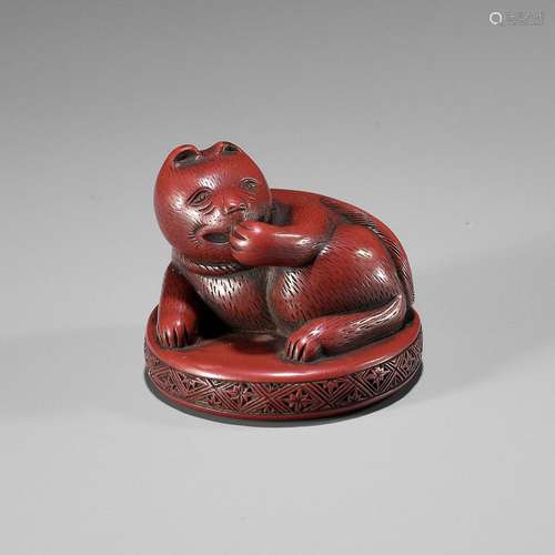 A RARE TSUISHU LACQUER NETSUKE OF A CAT