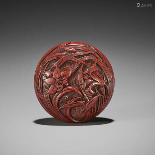 A FINE TSUISHU (CARVED RED LACQUER) MANJU NETSUKE WITH LILIE...
