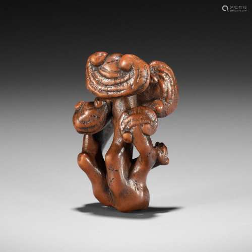 ZESHIN: A WOOD NETSUKE OF A REISHI FUNGUS WITH LACQUERED ANT...