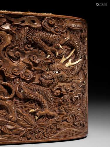 A LARGE AND FINE INLAID AND CARVED WOOD TONKOTSU WITH DRAGON...