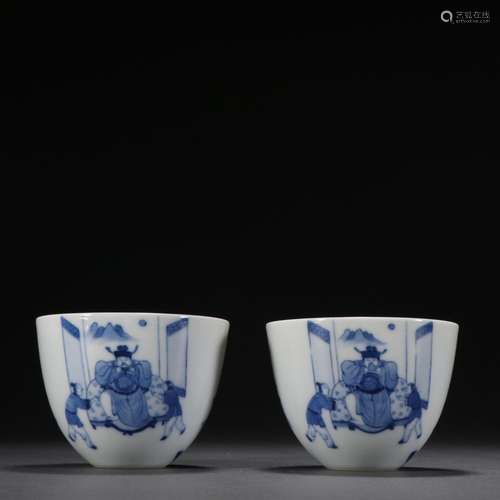 A pair of blue and white character story cups