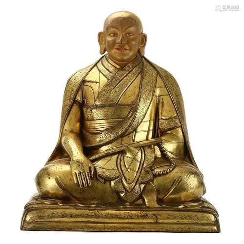 A BRONZE GILT LAMA FIGURE