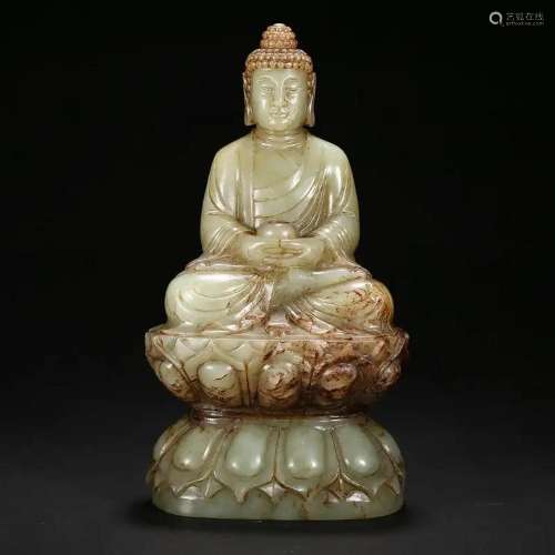 A CELADON JADE SEATED FIGURE OF SHAKYAMUNI BUDDHA