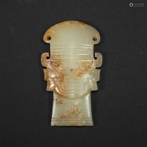 A CELADON JADE HUMAN FACE PENDANT