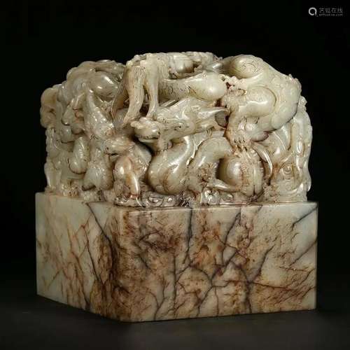 A MOTTLED WHITE JADE 'NINE DRAGONS' SEAL