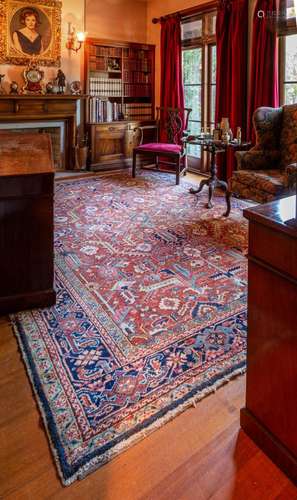 A large Heriz red ground geomeric design rug,circa 1900 325c...