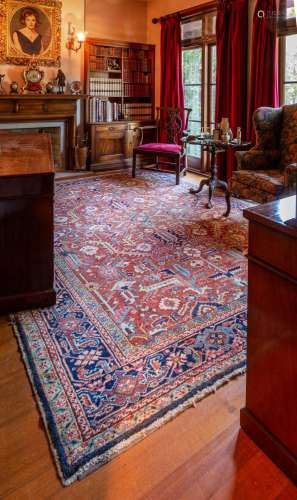 A large Heriz red ground geomeric design rug,circa 1900 325c...