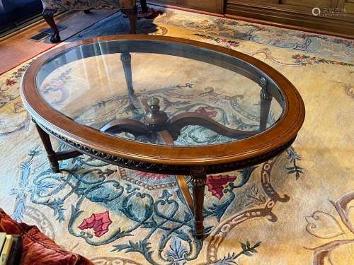 A good quality carved and gilt-metal mounted oval glass top ...