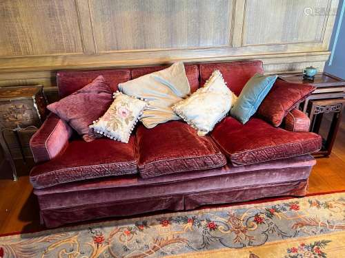 A pair of three-seater settee's covered in plum coloured...