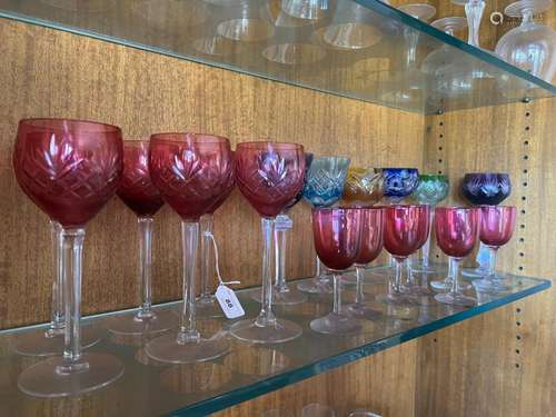 A collection of various cut coloured glass drinking glasses ...