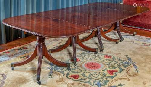 A fine and rare George III mahogany four-pillar dining table...